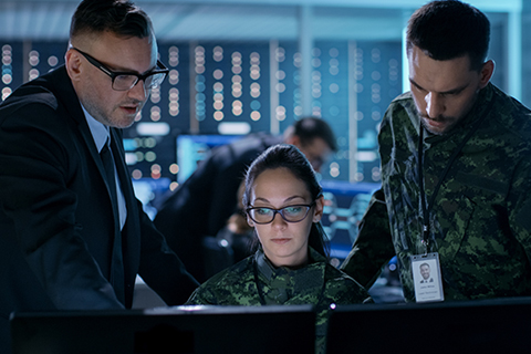 People working on a computer in server room